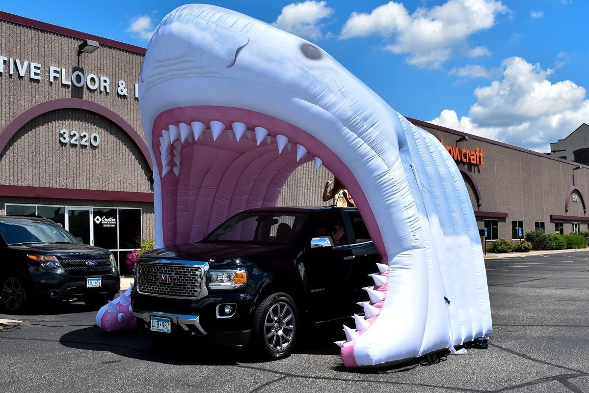 Inflatable shark tunnel with truck driving through