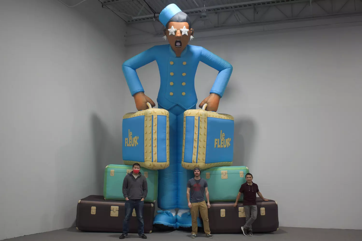 landmark employees next to custom inflatable bellhop