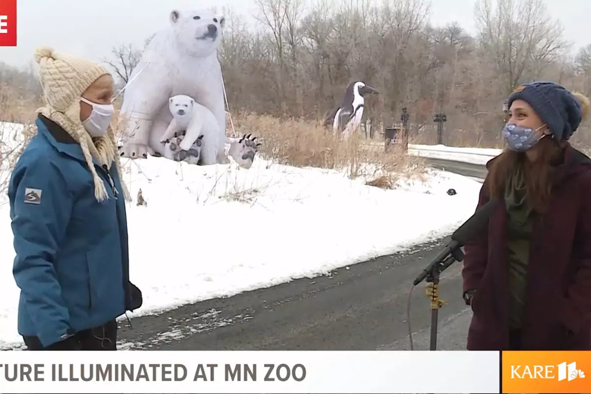 Lee Valsvik of Kare 11 and Stephanie Meacham in front of inflatable animals at the Minnesota Zoo