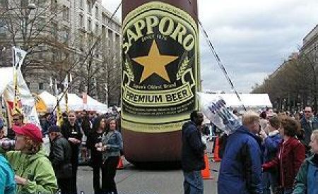 Inflatable Sapporo Beer Bottle Displayed at Cherry Blossom Festival
