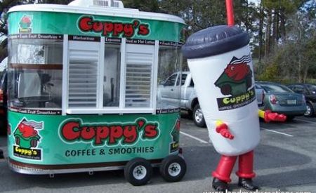 Inflatable drink cup costume in front of Cuppy's Coffee kiosk