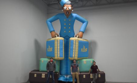 landmark employees next to custom inflatable bellhop
